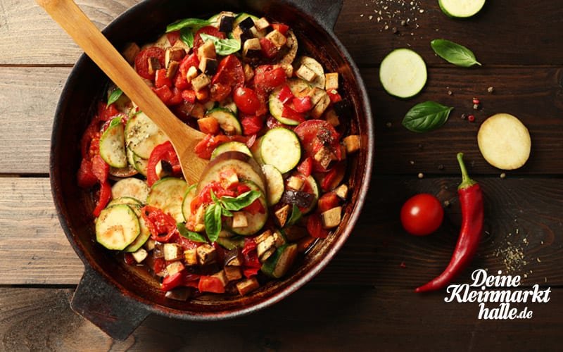 a pan of food with a wooden spoon